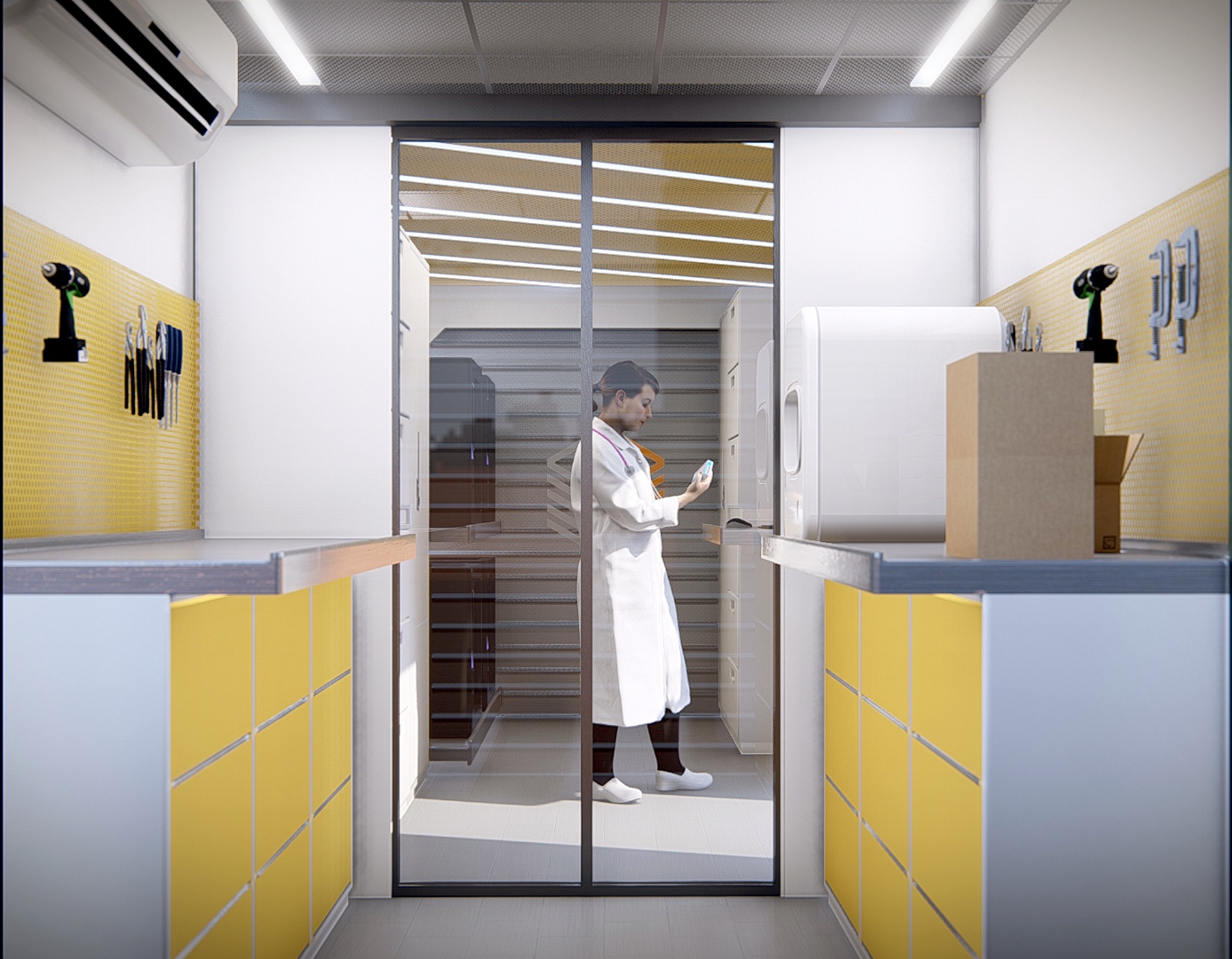 BuildingBloc deployable medical module interior with yellow cabinetry and healthcare worker behind glass.