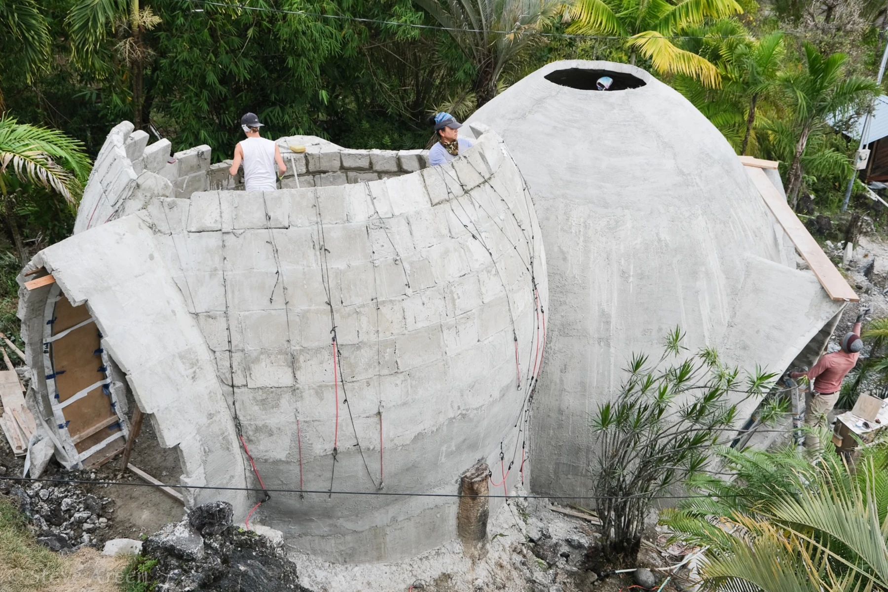 Overhead view of the aircrete dome and adjacent curved wall under construction.